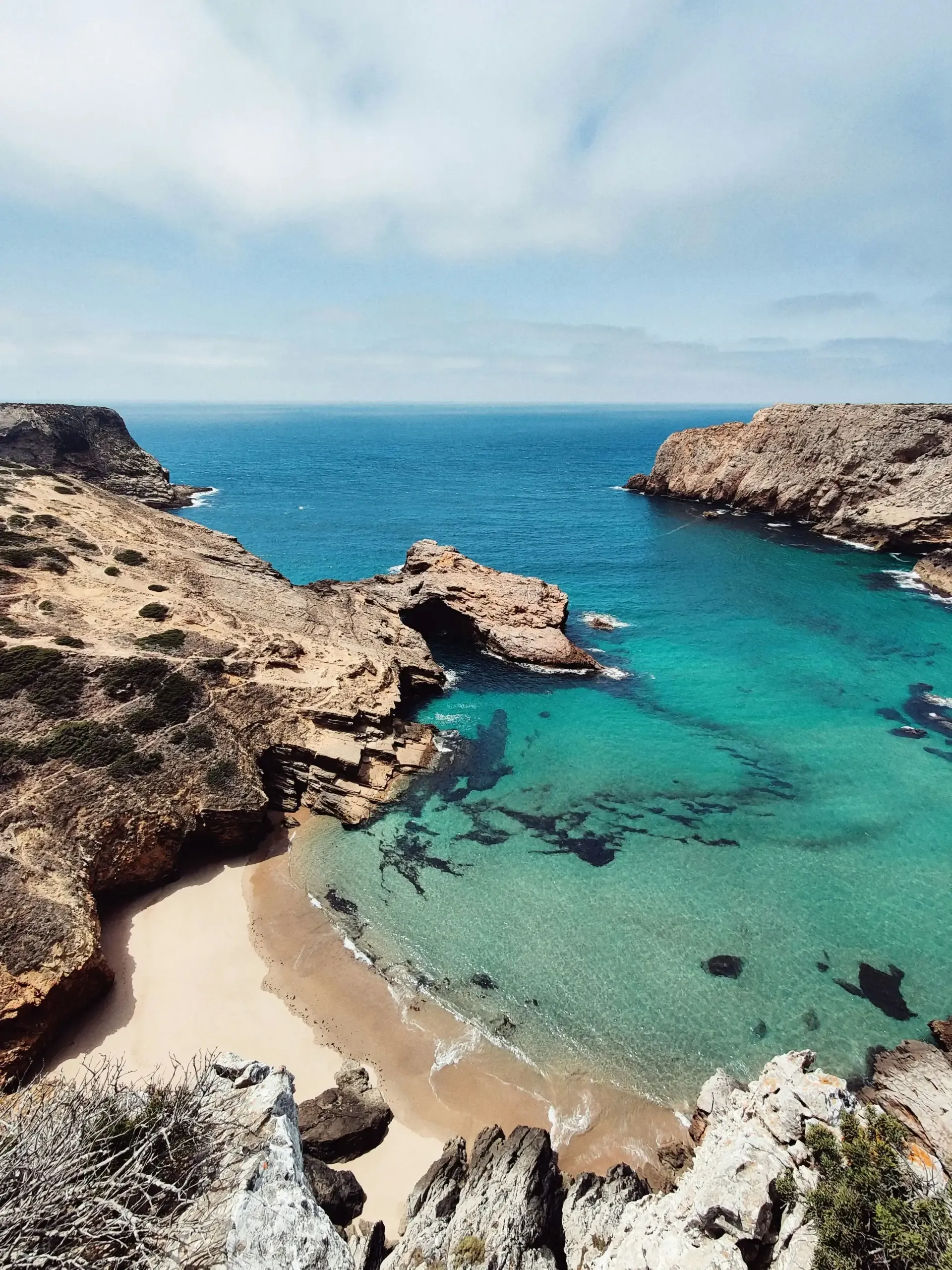 Turquoise cove between limestone cliffs on the Algarve coast