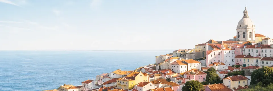 Lisbon's Alfama hillside rooftops overlooking the ocean